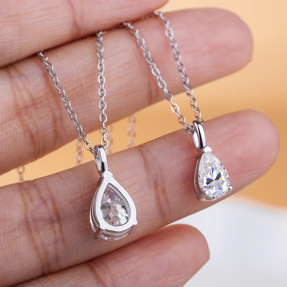 Pear moissanite pendant in polished silver for layering with necklaces, gift giving, and elegant daily wear.