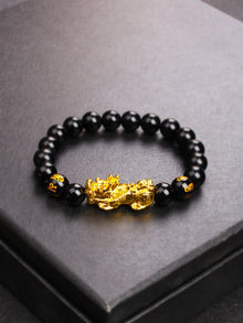 Pixiu Obsidian abundance bracelet for prosperity, energy shielding, and feng shui practice.