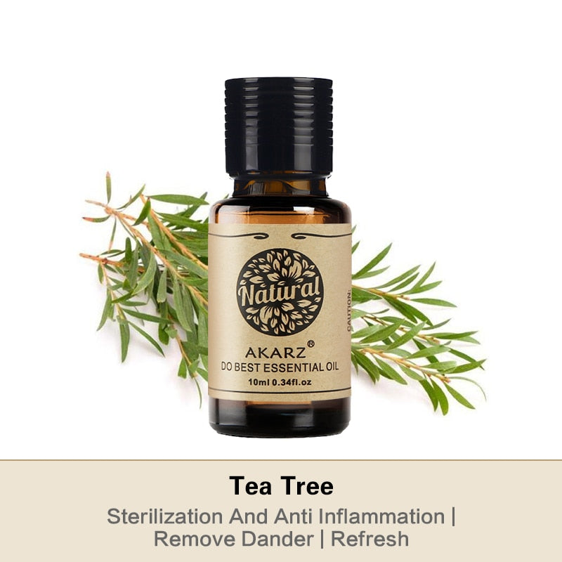 Akarz Tea Tree essential oil bottle with green leaves on a white background