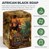 Raw African Black Soap bar with packaging featuring woman's face and green leaves on white background.