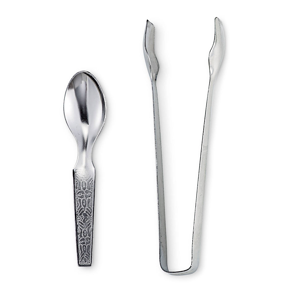 Resin and powder tong and spoon set close-up detail of metal tools for altar and incense use.