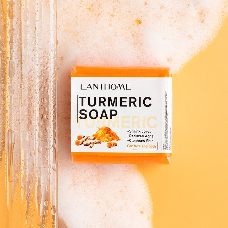 SAUVASINE Turmeric Handmade Soap for dark spots bar with packaging on textured yellow background.