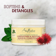 SheaMoisture Jamaican Black Castor Oil Leave-In Conditioner jar with natural elements on marble background.