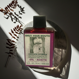 Shut Your Mouth Wish Oil ritual oil bottle for stopping rumors, calming harmful talk, and spiritual practice.