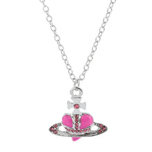 Trendy Silver Heart & Saturn Pendant necklace for celestial fashion looks, casual wear, and layering with other jewelry.