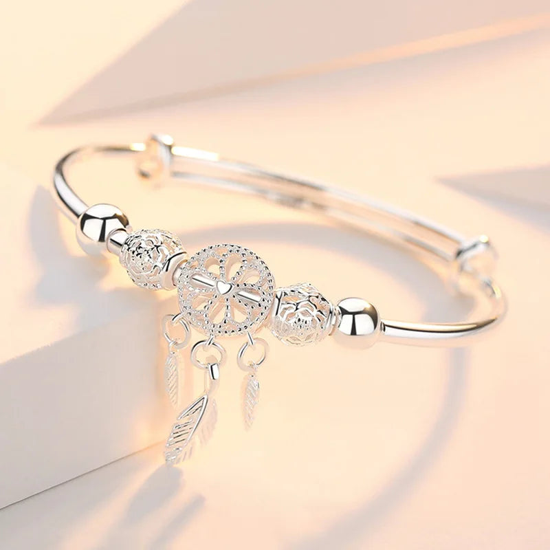 Silver Dreamcatcher charm feather bangle bracelet for boho-inspired accessorizing and everyday wristwear.