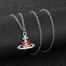Trendy Silver Heart & Saturn Pendant necklace for cosmic-inspired fashion, casual outfits, and modern accessory styling.