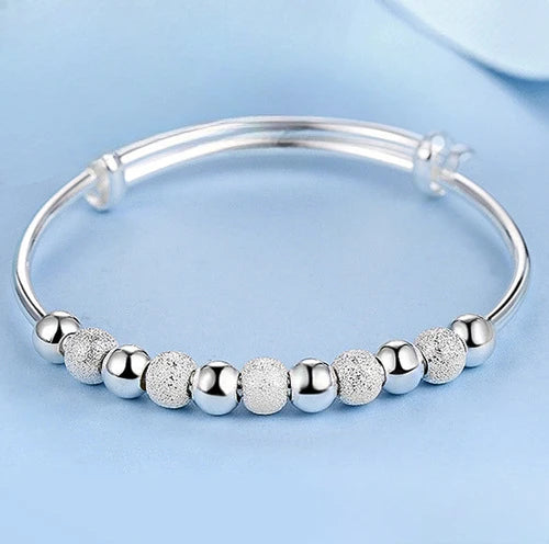 Silver Dreamcatcher Charm open bangle bracelet for easy wrist adjustment, casual wear, and layered jewelry looks.