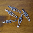 Skeleton charm for jewelry making, meditation malas, and gothic-themed accessories.