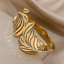 Slavena Gold Feather Rhinestone cuff bracelet for accessorizing dresses, occasion wear, and stylish layered jewelry looks.
