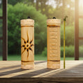 Small fire-burned rainstick with sun design percussion instrument for meditation music, sound rituals, and decorative display.