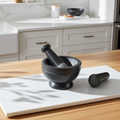 Soapstone gray and black 2-tone mortar and pestle set for grinding spices, herbs, and seasoning blends during kitchen prep.
