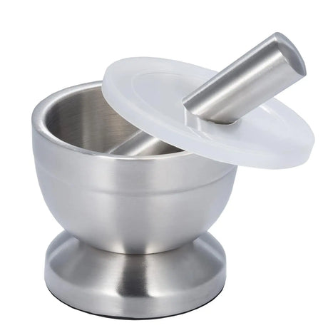 Stainless steel grinding bowl with pestle and lid for crushing herbs, spices, and dry ingredients in the kitchen.