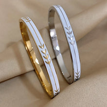 Stainless steel leaf cuff bangle with enamel detailing for casual outfits and elegant accessorizing.