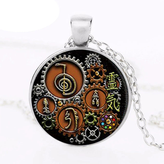 Steampunk Reiki glass cabochon pendant jewelry piece for energy healing, spiritual wear, and everyday accessory styling.