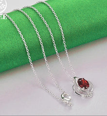 Sterling silver bud pendant with red zircon stone for necklace making, personal styling, and gift use.