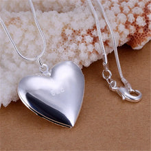 Sterling silver heart photo locket pendant for holding a cherished picture and meaningful gift giving.