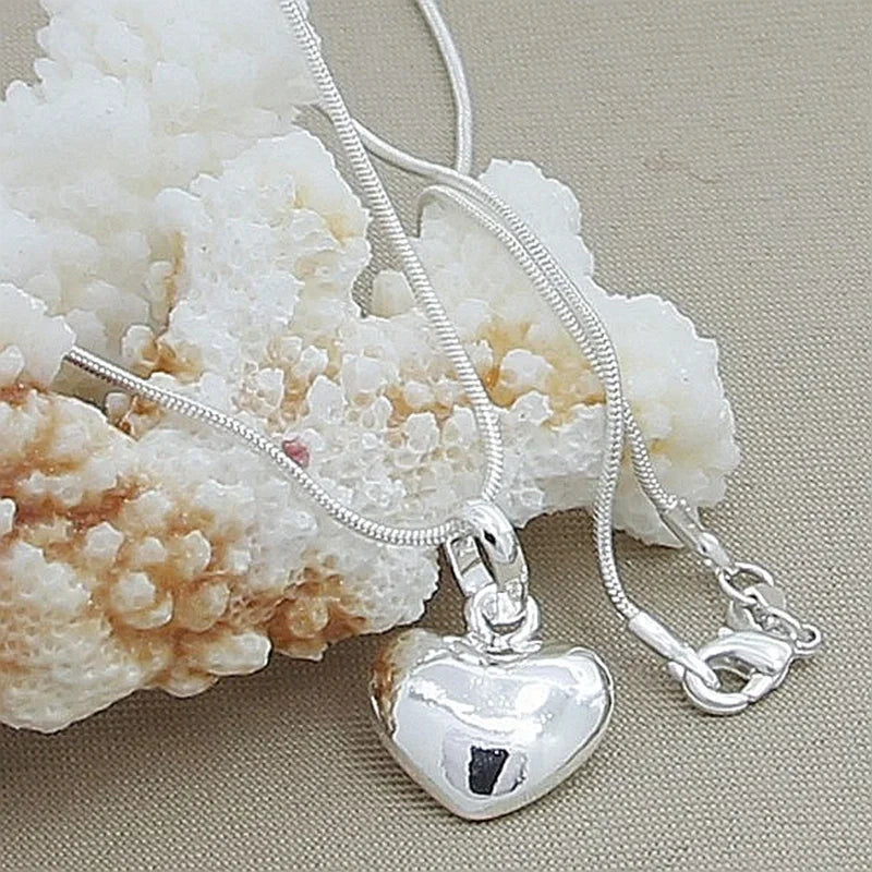 Sterling Silver small heart charm pendant for casual outfits, sentimental gifting, and simple jewelry looks.