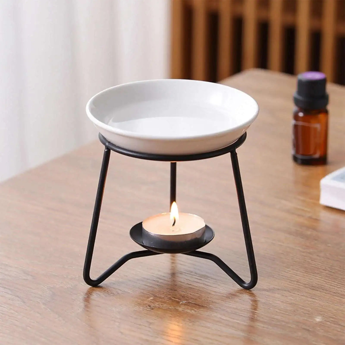 Stylish copper fragrance oil warmer with tealight holder for scented oil diffusion and cozy indoor fragrance use.