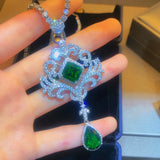 Teardrop emerald zircon stone pendant for wedding guest styling, statement accessorizing, and festive wear.