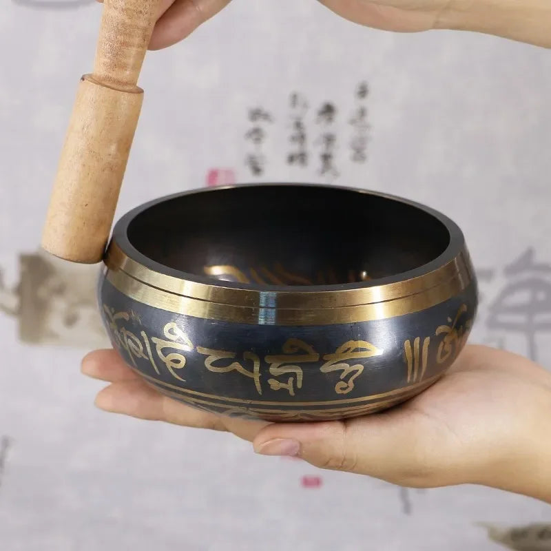 Traditional Handmade Tibetan Singing Bowl Set with metal bowl, striker, and cushion for yoga, meditation, and calming rituals.