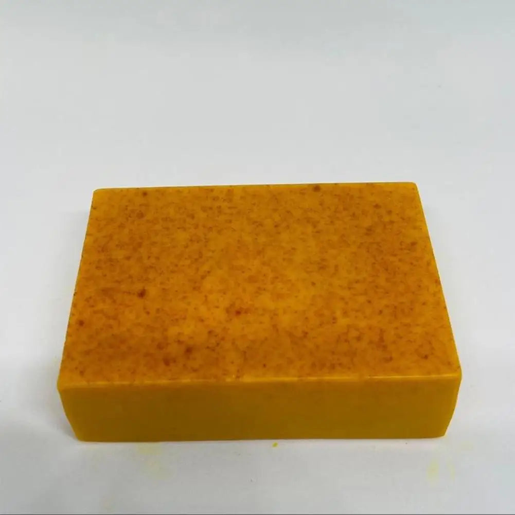 Handmade Turmeric Kojic Acid Soap orange bar on sponge for gentle daily face and body cleansing.
