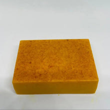 Handmade Turmeric Kojic Acid Soap orange bar on sponge for gentle daily face and body cleansing.