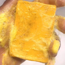 Handmade Turmeric Lemon Kojic Acid Soap bar held in hand for daily brightening facial cleanse.
