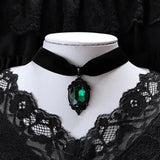 Velvet gothic choker with green crystal cameo pendant for Victorian-inspired fashion, gothic events, and layered jewelry styling.