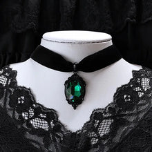 Velvet gothic choker with green crystal cameo pendant for Victorian-inspired fashion, gothic events, and layered jewelry styling.