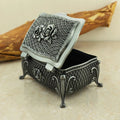 Vintage metal flower jewelry box with decorative floral design for storing rings, earrings, and keepsake jewelry.