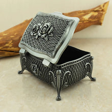 Vintage metal flower jewelry box with decorative floral design for storing rings, earrings, and keepsake jewelry.