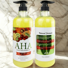 Two bottles of AHA beauty skin shower gel with fruit illustrations on labels.