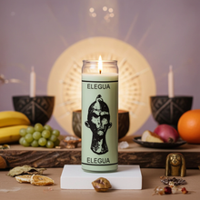 White Elegua prayer candle in tall glass container for prayer, protection, and spiritual ceremony use.