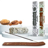 Incense sticks with packaging, white sage, and wooden incense holder on a white background