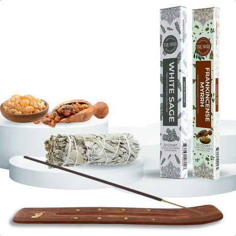 Incense sticks with packaging, white sage, and wooden incense holder on a white background