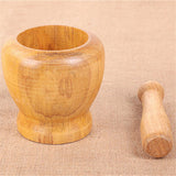 Wooden bamboo mortar and pestle grinder for blending dry spices, seeds, and homemade seasoning mixes.