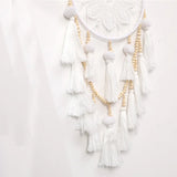 Woven dreamcatcher wind chime with Nordic tassels for nursery decor, window hanging, and bohemian room accent use.