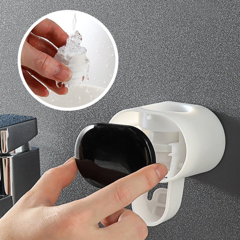 Automatic Toothpaste Dispenser mounted on wall keeping bathroom counter clean and clutter-free.