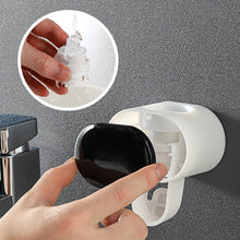 Automatic Toothpaste Dispenser mounted on wall keeping bathroom counter clean and clutter-free.