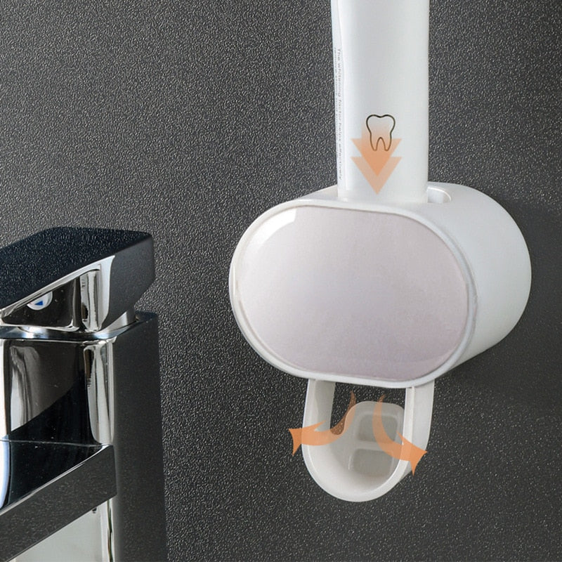 Automatic Toothpaste Dispenser with toothbrush holder slots for organized bathroom storage.
