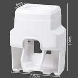 Wall Mount Automatic Toothpaste Dispenser mounted in bathroom for tidy toothbrush and paste storage.