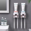 Wall Mount Automatic Toothpaste Dispenser installed on bathroom wall with integrated toothbrush holder.