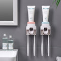 Wall Mount Automatic Toothpaste Dispenser installed on bathroom wall with integrated toothbrush holder.