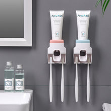 Wall Mount Automatic Toothpaste Dispenser installed on bathroom wall with integrated toothbrush holder.