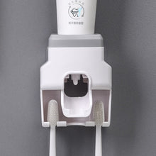 Wall Mount Automatic Toothpaste Dispenser with three toothbrush slots and anti-drip dispenser mechanism.